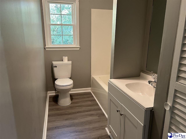 bathroom featuring vanity, hardwood / wood-style flooring, and toilet