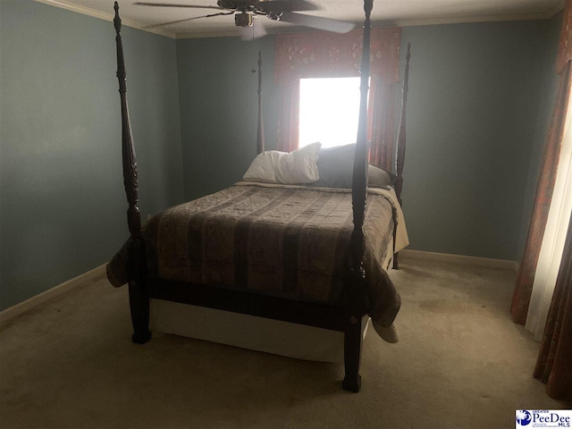 bedroom with baseboards, crown molding, a ceiling fan, and light carpet