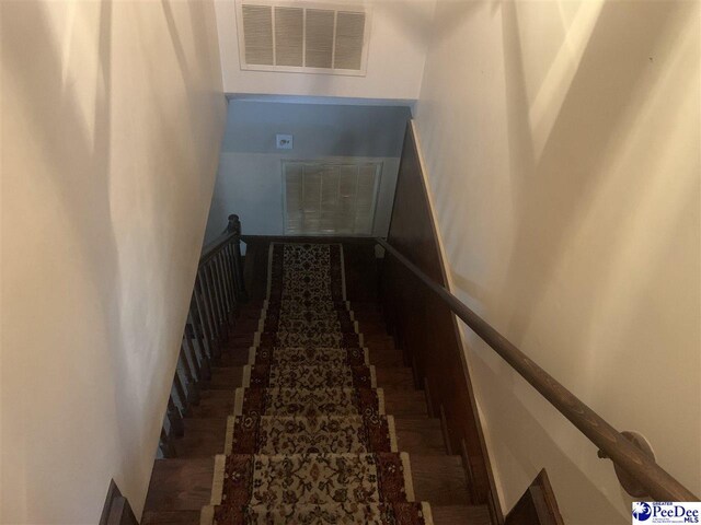 stairway featuring visible vents