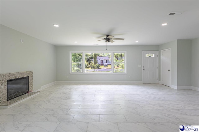 unfurnished living room with ceiling fan, visible vents, recessed lighting, a premium fireplace, and marble finish floor