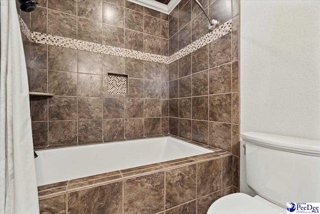 bathroom featuring shower / bathtub combination with curtain and toilet