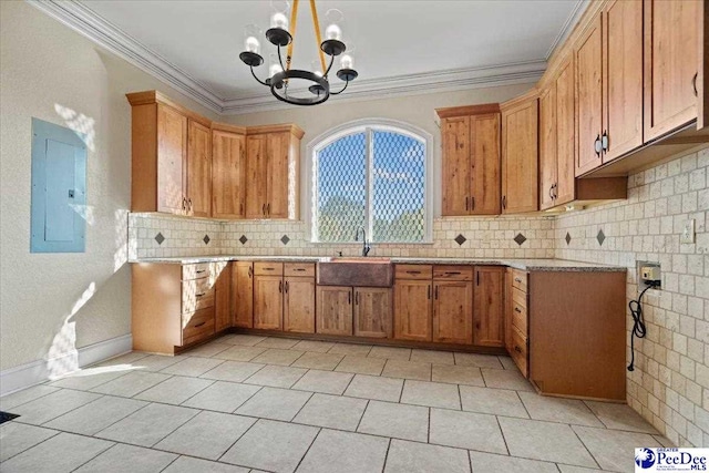 kitchen with sink, crown molding, an inviting chandelier, backsplash, and electric panel