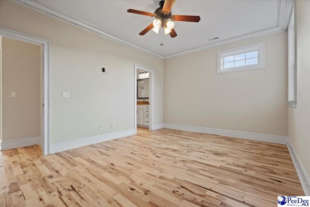 empty room featuring crown molding, ceiling fan, and light hardwood / wood-style floors