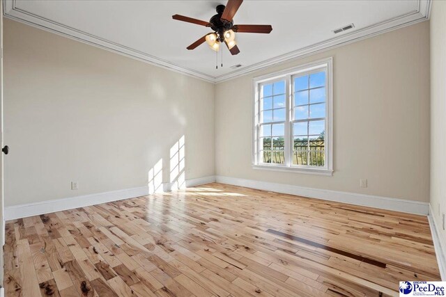 spare room with crown molding, ceiling fan, and light wood-type flooring