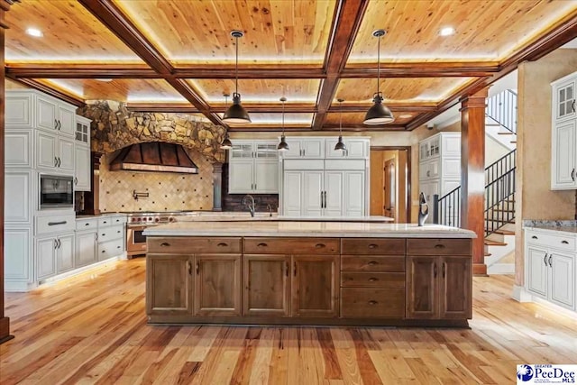 kitchen with white cabinets and decorative light fixtures