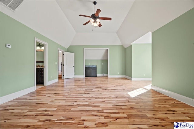 unfurnished living room featuring ceiling fan, lofted ceiling, and light hardwood / wood-style floors