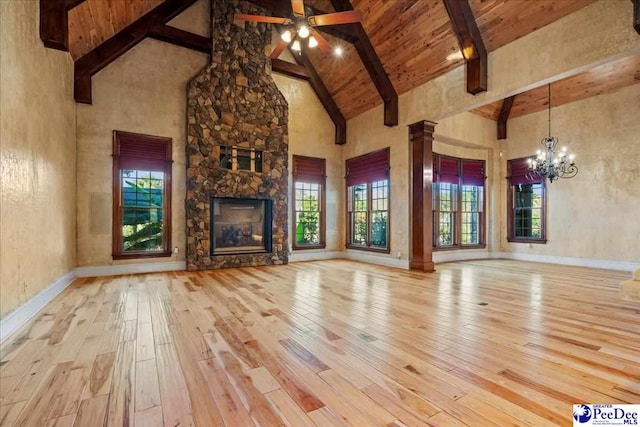 unfurnished living room with beamed ceiling, wood-type flooring, a fireplace, and high vaulted ceiling