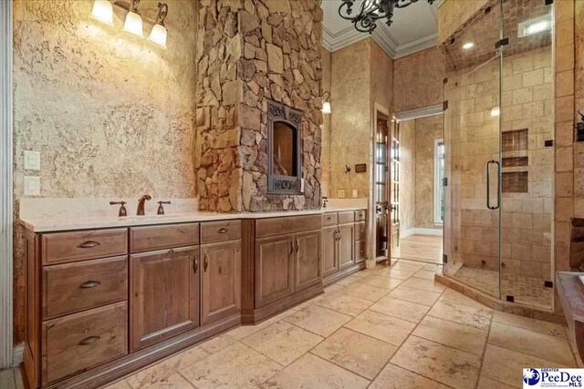 bathroom featuring ornamental molding, vanity, and walk in shower