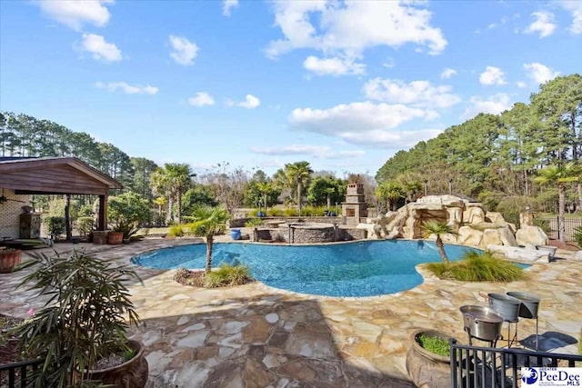 view of pool with a gazebo, a fireplace, and a patio