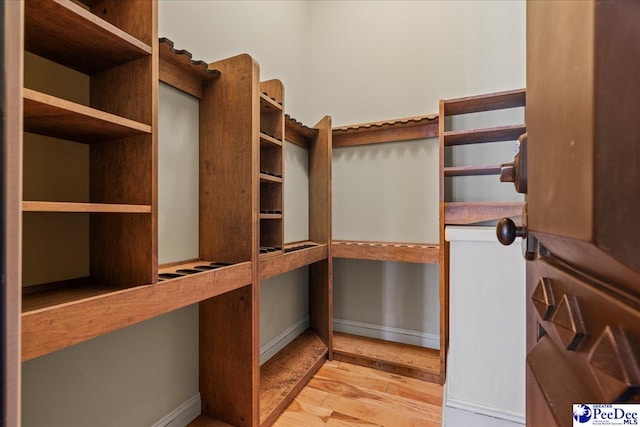 spacious closet with light hardwood / wood-style floors