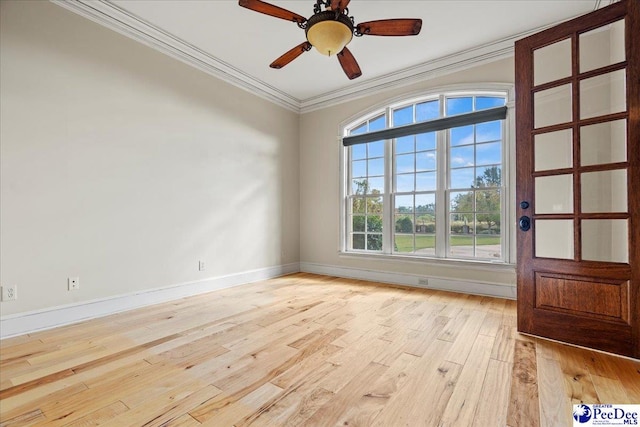 unfurnished room with ornamental molding, ceiling fan, and light wood-type flooring