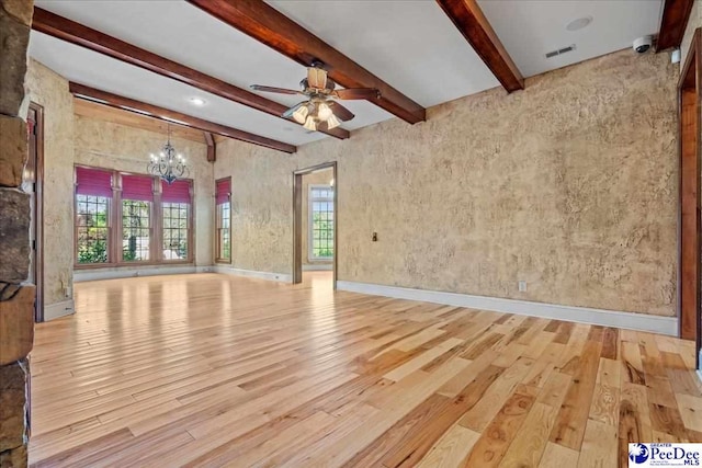 unfurnished living room featuring beam ceiling, ceiling fan with notable chandelier, and light wood-type flooring