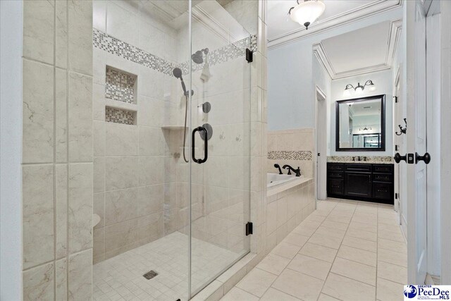 bathroom with tile patterned flooring, ornamental molding, vanity, and plus walk in shower