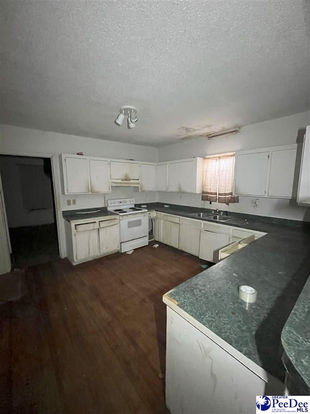 kitchen with dark wood-style floors, dark countertops, a sink, and electric range