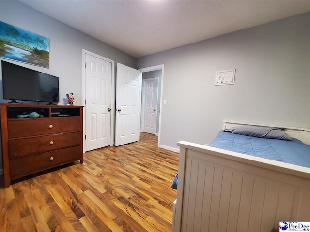 bedroom with light wood-type flooring