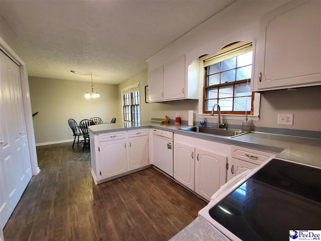 kitchen featuring pendant lighting, white dishwasher, sink, and white cabinets