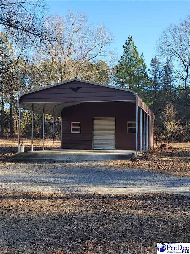 view of car parking with a garage and a carport