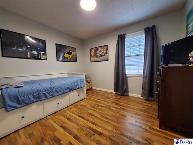 bedroom with hardwood / wood-style floors