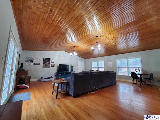 living room featuring lofted ceiling, wood ceiling, light hardwood / wood-style floors, and a chandelier