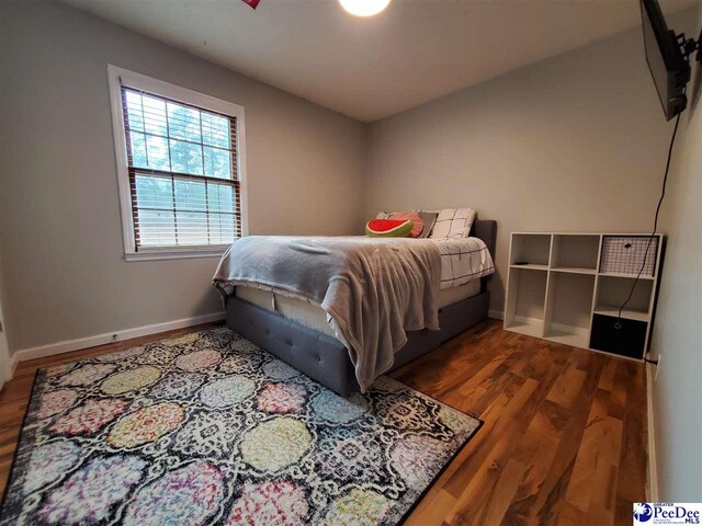 bedroom with wood-type flooring