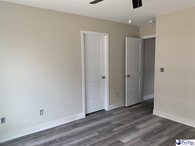 unfurnished room featuring dark hardwood / wood-style flooring and ceiling fan