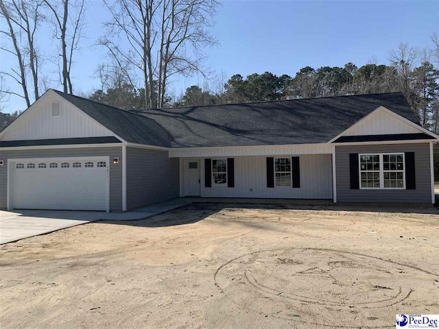 single story home featuring a garage and driveway