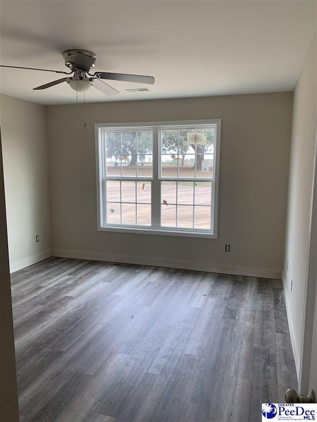 empty room featuring dark hardwood / wood-style flooring and ceiling fan