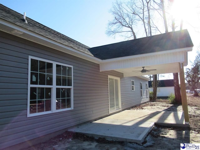 exterior space with ceiling fan