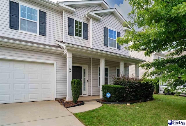 view of front facade with an attached garage, concrete driveway, a porch, and a front lawn
