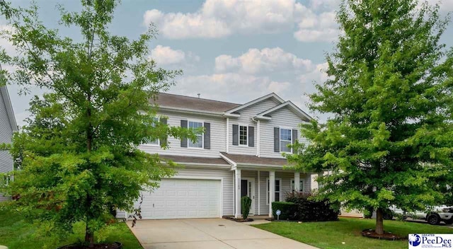 view of front of property featuring an attached garage, a front lawn, and concrete driveway
