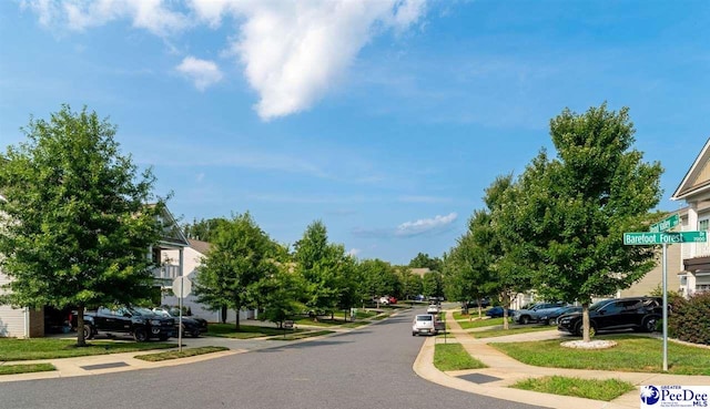view of street with curbs, traffic signs, and sidewalks