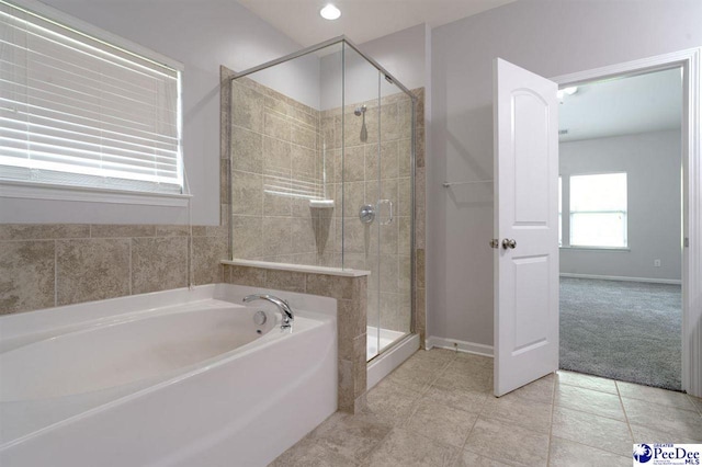 full bath featuring tile patterned floors, a shower stall, baseboards, and a bath