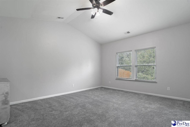 spare room featuring visible vents, a ceiling fan, lofted ceiling, and carpet flooring