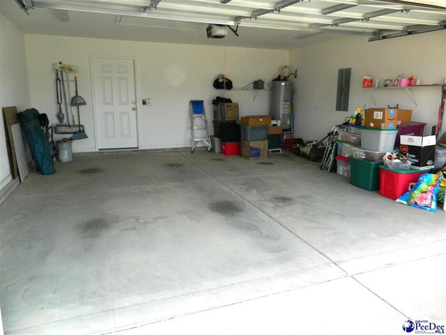 garage with water heater, a garage door opener, and electric panel
