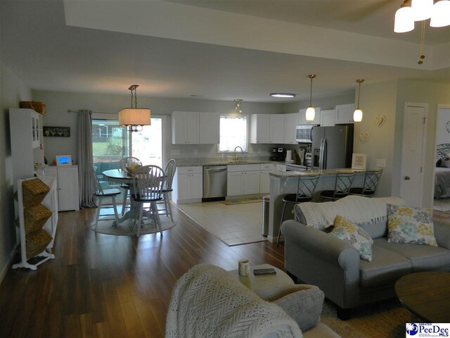 living room with wood finished floors and ceiling fan
