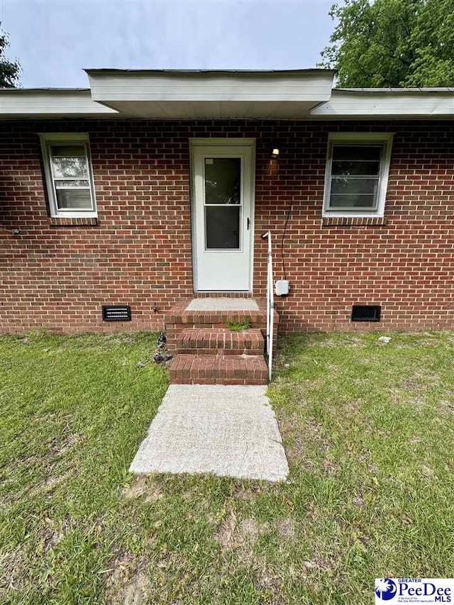 301 Mont Clare Rd, Darlington, SC 29540 - property entrance featuring brick siding, a yard, and crawl space