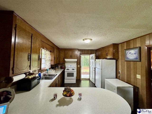 301 Mont Clare Rd, Darlington, SC 29540 - kitchen featuring wooden walls, white appliances, a sink, and a healthy amount of sunlight