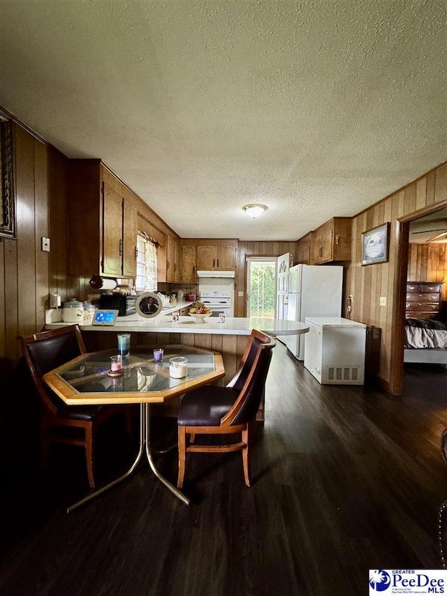 301 Mont Clare Rd, Darlington, SC 29540 - dining space with wood walls, a textured ceiling, and dark wood finished floors