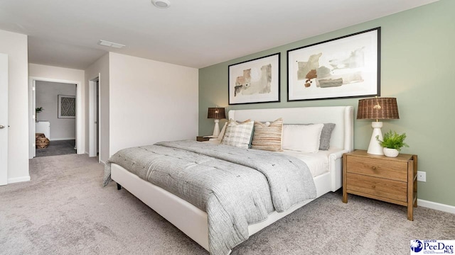 bedroom with baseboards, visible vents, and light carpet