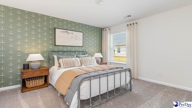 bedroom with baseboards, wallpapered walls, visible vents, and carpet