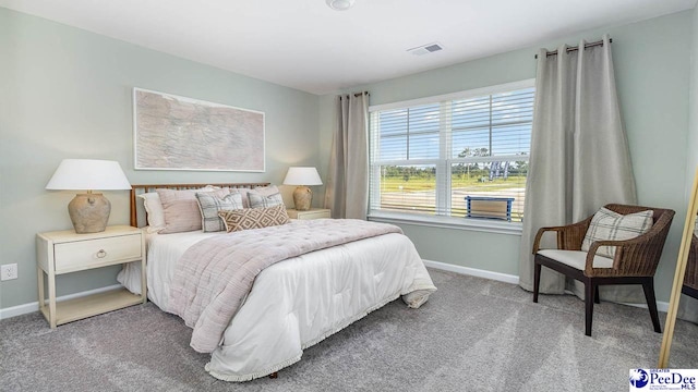 carpeted bedroom featuring baseboards and visible vents