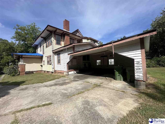 view of property exterior with a carport