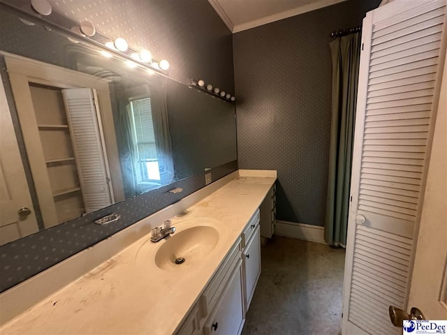 bathroom with ornamental molding and vanity