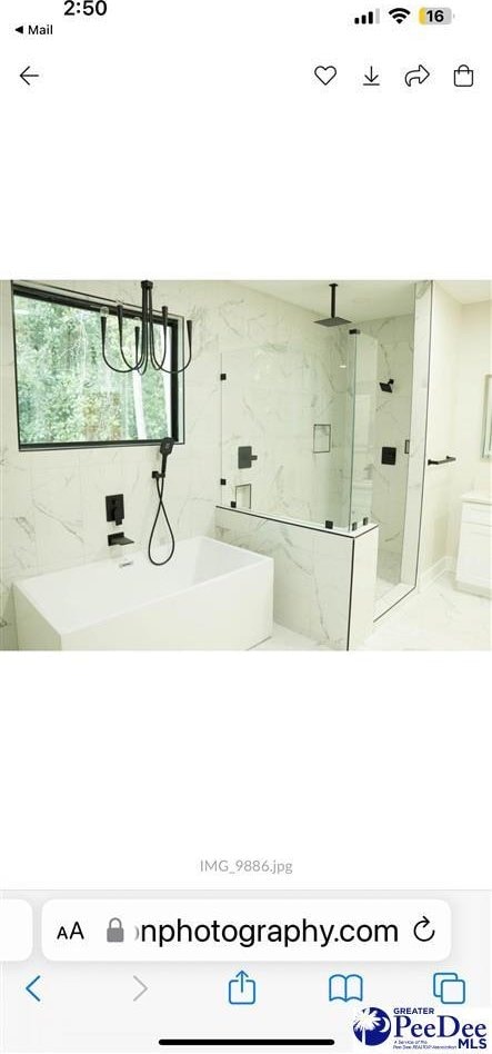 1005 Tunbridge Pl, Florence, SC 29501 - full bath featuring a marble finish shower, a chandelier, and marble finish flooring