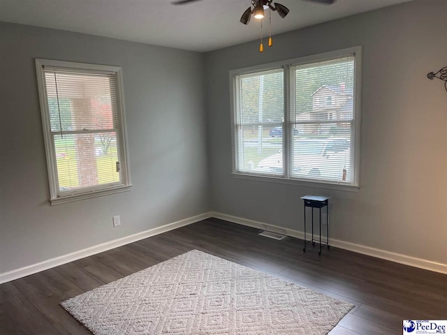 unfurnished room featuring dark hardwood / wood-style floors and ceiling fan