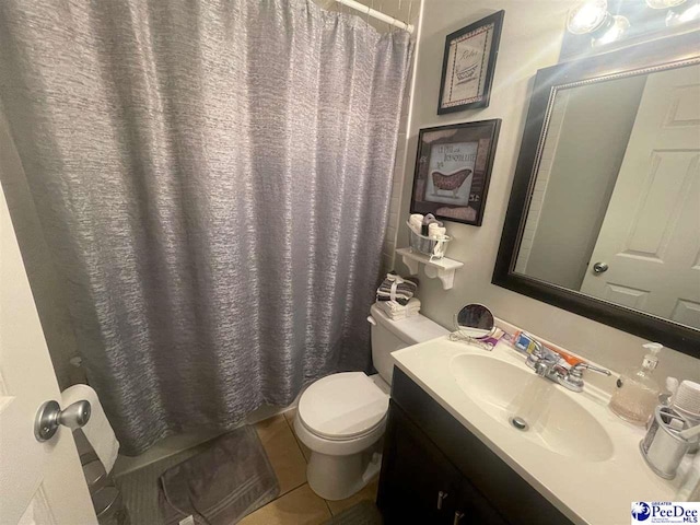 bathroom featuring tile patterned floors, toilet, curtained shower, and vanity