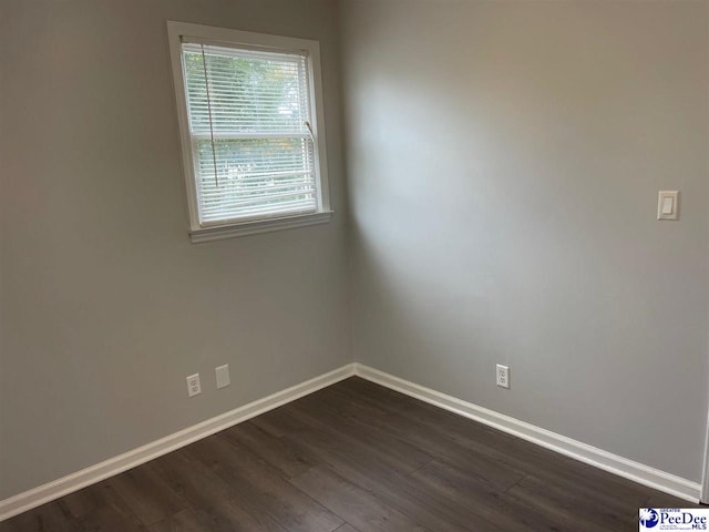 unfurnished room featuring dark hardwood / wood-style floors