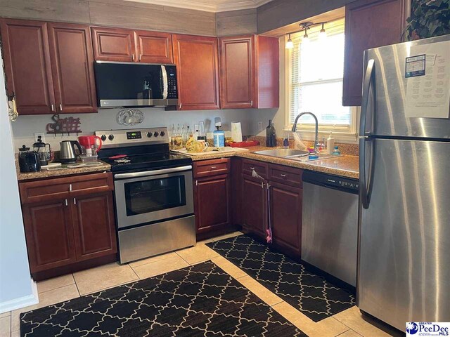 kitchen featuring sink, light tile patterned floors, and appliances with stainless steel finishes