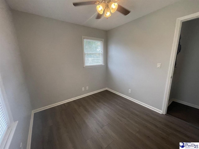 empty room featuring dark hardwood / wood-style floors and ceiling fan