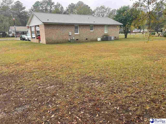 exterior space featuring a lawn and central air condition unit